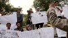 FILE - A Sept. 2014 photo shows protesters holding posters during a rally against the Islamic State group, in Jakarta, Indonesia.