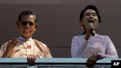 FILE - In this Nov. 9, 2015, photo, Myanmar's pro-democracy icon Aung San Suu Kyi, right, delivers a speech as close ally Tin Oo waves in Yangon, Myanmar. Tin Oo died June 1, 2024, at the age of 97.