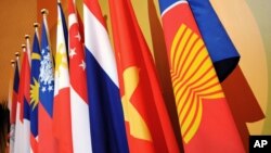 The Association of the Southeast Asian Nations (ASEAN) flag, right, leads the flags of the 10 member countries during the ASEAN Regional Forum meeting.