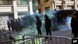 Catalan police secure the area from pro-independence demonstrators in Barcelona Spain, Friday Dec. 21, 2018.