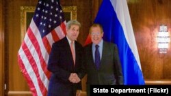 FILE - U.S. Secretary of State John Kerry shakes hands with Foreign Minister Sergey Lavrov. The two officials talked by phone Friday about widening international political talks on Syria. 