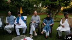 Former Jammu and Kashmir Chief Minister Mehbooba Mufti, second right, National Conference president Farooq Abdullah, center, and other leaders sit during an all parties meeting in Srinagar, India, Aug. 4, 2019. 