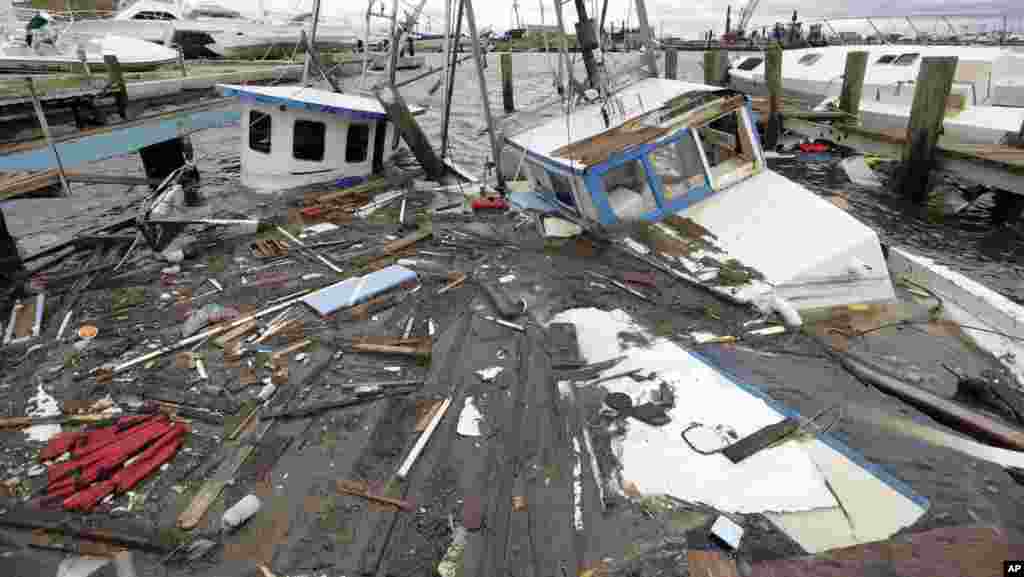 Boats that sunk in the wake of Hurricane Harvey are surrounded by floating debris Sunday, Aug. 27, 2017, in Rockport, Texas. (AP Photo/Eric Gay)