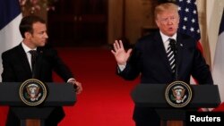 French President Emmanuel Macron listens to U.S. President Donald Trump speak during their joint news conference at the White House in Washington, April 24, 2018.