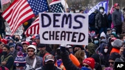 FILE - In this Jan. 6, 2021 photo, Trump supporters gather outside the Capitol in Washington.