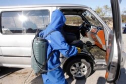 29일 북한 강원도 원산시에 들어오는 차량을 신종 코로나바이러스 방역요원이 소독하고 있다.