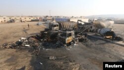 A general view shows damaged trucks after what activists said were airstrikes carried out by the Russian air force, on a parking garage for cargo trucks in al-Dana town, near the Syrian-Turkish border in Idlib Governorate, Nov. 28, 2015.