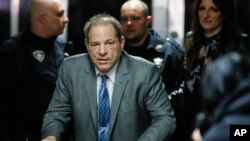 FILE - Harvey Weinstein leaves a Manhattan courthouse during his rape trial, Feb. 18, 2020, in New York.