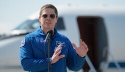 In this photo provided by NASA astronaut Bob Behnken speaks at a news conference after he arrived at the Kennedy Space Center in Cape Canaveral, Fla., May 20, 2020.
