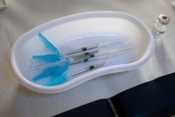 Syringes and a vial of AstraZeneca vaccine against COVID-19 sit on a general practitioners' table during a vaccination campaign in Amsterdam, Netherlands, April 14, 2021.