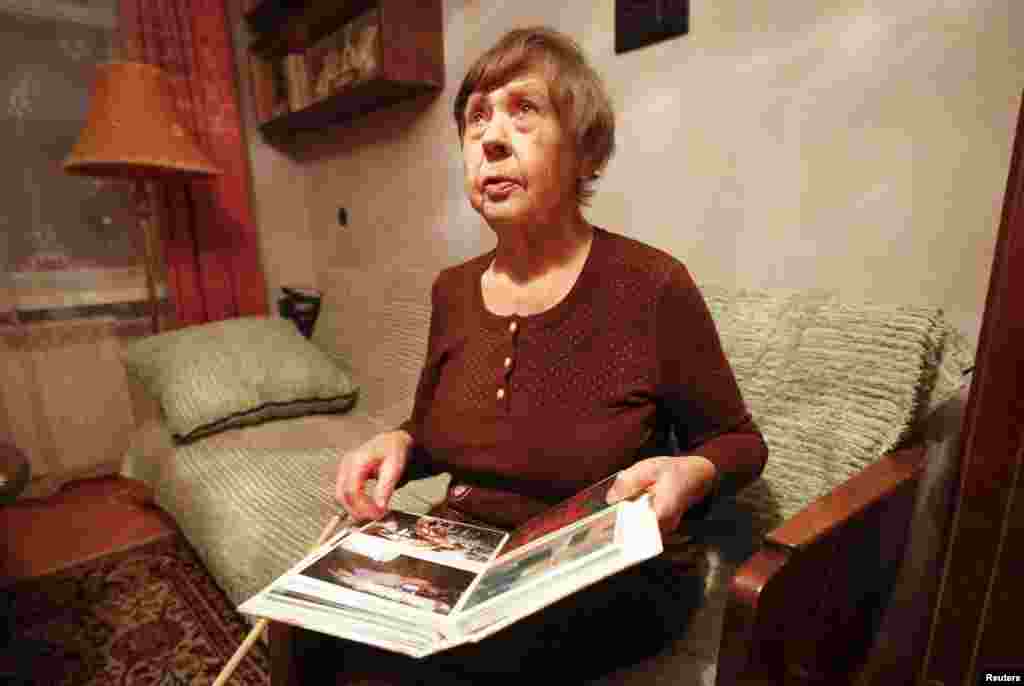 Varvara Tolokonnikova, grandmother of Nadezhda Tolokonnikova, shows family photos of Nadezhda at her apartment, as she waited for her granddaughter&#39;s release from prison, Dec. 21, 2013.&nbsp;