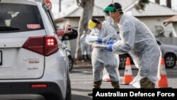 Australian Army soldiers confirm driver'’s details at the Colac COVID-19 testing site in this photo provided by the Australian Defence Force.