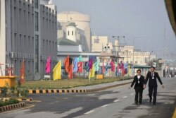FILE - Pakistani officials walk before the inaugural ceremony of The Chashma-III reactor, a collaboration with China, in Chashma, in this handout photograph released by Pakistan Prime Minister's Office, Dec. 28, 2016.