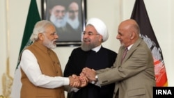 Afghanistan president and India prime minister shake hand with Rouhani, Iran president, May 2016.