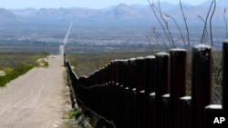 FILE - A U.S. Customs and Border Patrol truck patrols the U.S. border with Mexico in Douglas, Ariz., March 18, 2016.