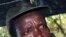 The leader of the Lord's Resistance Army, Joseph Kony, answers journalists' questions following a meeting with UN officials in southern Sudan, Nov 2006 (file photo)