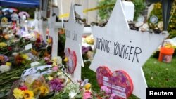 FILE - Flowers and other items have been left as memorials outside the Tree of Life synagogue following last Saturday's shooting in Pittsburgh, Pennsylvania, Nov. 3, 2018.