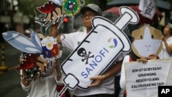 Protesters display slogans during a rally against the controversial immunization of more than 700,000 Filipino children with the anti-dengue vaccine Dengvaxia in Manila, Philippines, Dec. 18, 2017. The controversial vaccine, manufactured by Sanofi Pasteur was recently put on hold by the Philippines after new study findings showed it posed risks of severe cases in people without previous infection. The controversy has prompted the Philippine Senate to conduct an investigation.