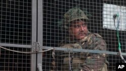 Seorang tentara India mengamati dari dalam kendaraan militer di pangkalan udara Pathankot, India, 4 Januari 2016 (Foto: dok).