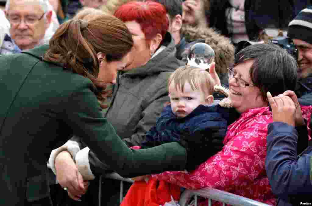 Catherine, Duchess of Cambridge, greets people outside the Blackpool Tower in Blackpool, Britain.