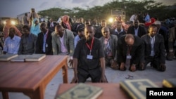 FILE - New Somali parliamentarians pray during an inauguration ceremony for members of Somalia's first parliament in 20 years in Mogadishu, Aug. 20, 2012.