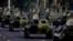 FILE - Cuban military vehicles parade along the Plaza de la Revolucion to mark the 50th anniversary of the failed Bay of Pigs invasion in Havana, April 16, 2011. 