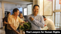 Siraphop Kornaroot poses for a photo moments after his release from jail in Bangkok, June 11, 2019. 