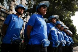 Drivers of the food delivery service Ele.me attend a morning briefing before an internal security check in Beijing, China, Sept. 21, 2017.