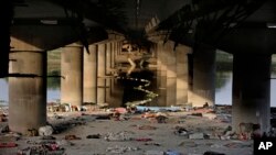 Beddings and other belongings of Indian migrant laborers and homeless people lie scattered after they were evicted from the banks of Yamuna River where they were squatting during lockdown in New Delhi, India, April 15, 2020.