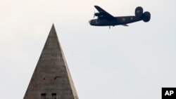 A B-24 Liberator, the bomber Tom Kelly flew in WW II, flies over Washington, D.C. Kelly's plane was shot down and crashed in the Pacific Ocean near Papua New Guinea in 1944.