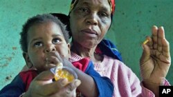 HIV positive child is given some jam prior to her ARV medication by a care giver near Durban South Africa, November 2010 (file photo)