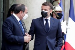 French President Emmanuel Macron leaves with Egyptian President Abdel Fattah el-Sissi after their talks at the Elysee Palace in Paris, France May 17, 2021.