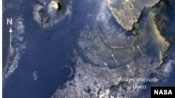 This view of layered rocks on the floor of McLaughlin Crater shows sedimentary rocks on Mars that contain spectroscopic evidence for minerals formed through interaction with water. 