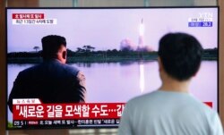 FILE - A man watches a TV showing a file image of a North Korea's missile launch during a news program at the Seoul Railway Station in Seoul, Aug. 6, 2019.