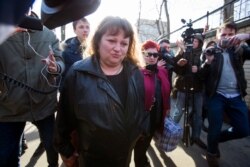 FILE - Oksana Sevastidi, center, surrounded by journalists, leaves the Lefortovo prison in Moscow, Russia, March 12, 2017.