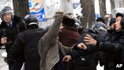 Kazakh riot police officers detain demonstrators during an opposition rally in Kazakhstan's commercial capital Almaty, December 17, 2011.