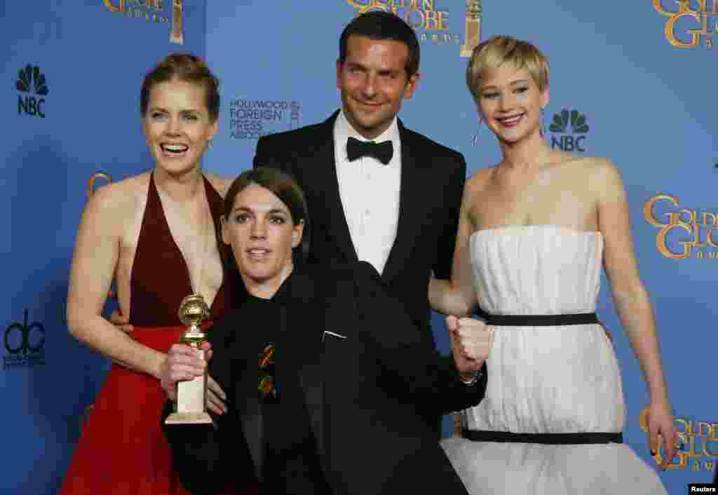 &quot;American Hustle&quot; stars Amy Adams, Bradley Cooper and Jennifer Lawrence pose with producer Megan Ellison after the film won the award for Best Motion Picture, Musical or Comedy at the Golden Globe Awards, Jan. 12, 2014.
