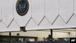 Seorang pekerja memperbaiki pintu masuk Kedutaan AS di Sanaa yang rusak (foto: dok). Seorang bersenjata dengan sepeda motor telah menewaskan pejabat keamanan Kedutaan AS, Kamis (11/10). 