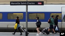 People walk on a platform to take a train, at the Saint-Charles railway station, in Marseille, southern France, June, 1, 2016. 