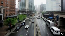 In this June 4, 2018 photo, buildings under construction and finished buildings line Seaport Boulevard in Boston's Seaport District.