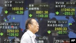 A man walks by an electronic stock board of a securities firm in Tokyo, September 5, 2011.