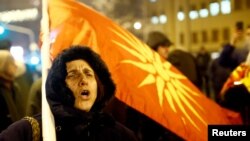 FILE - Supporters of the movement boycotting the deal with Greece to change the country's name to the Republic of North Macedonia protest in front of the parliament during parliamentary debates on constitutional amendments related to the name change, in Skopje, Jan. 11, 2019.