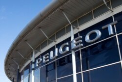 FILE - In this Nov. 2, 2019, file photo, the logo of French automaker Peugeot is pictured in Villeneuve d'Ascq, northern France.
