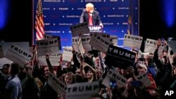 Supporters turn to show their support as a protestor interrupts an address by Republican presidential candidate Donald Trump during a campaign stop at the Flynn Center of the Performing Arts in Burlington, Vt., Jan. 7, 2016.