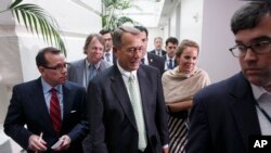 Speaker of the House John Boehner of Ohio, is surrounded by reporters on Capitol Hill in Washington, Aug. 1, 2014, after a closed-door meeting of House Republicans to discuss the border crisis. 