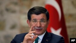 FILE - Turkish Prime Minister Ahmet Davutoglu speaks to a group of foreign reporters in Istanbul, Turkey, Dec. 9, 2015. 
