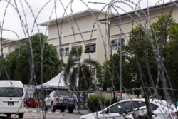 Exterior of workers' hostel for Top Glove, the world's largest glove maker, is seen through barricade amid the COVID-19 outbreak in Meru, Selangor state, Malaysia, Nov. 24, 2020.