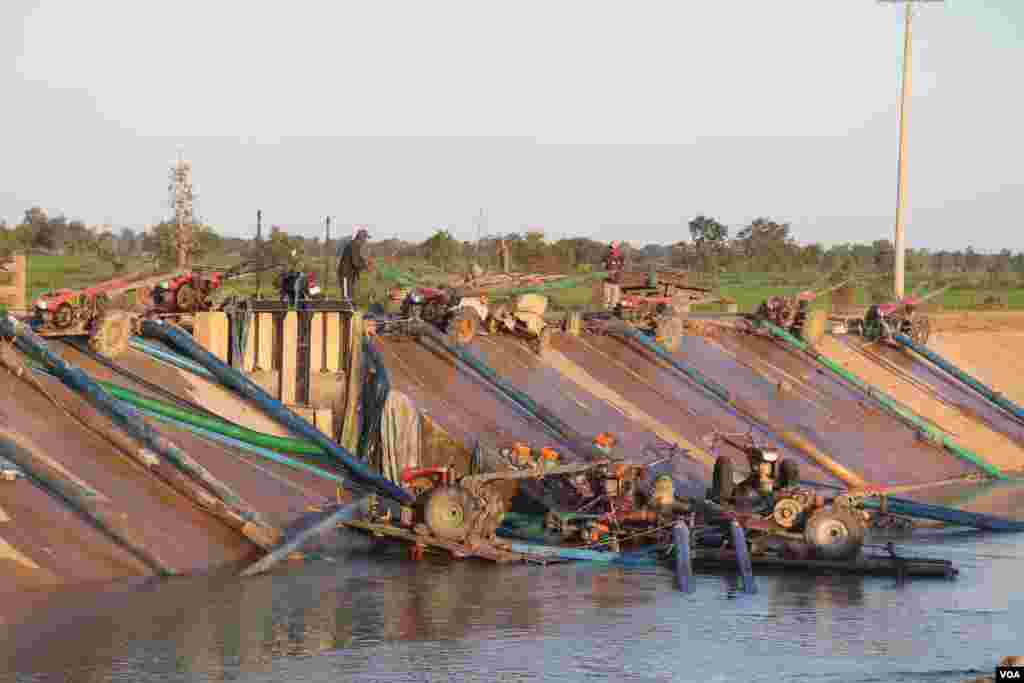 កសិករដាក់គោយន្តក្នុងប្រឡាយទឹក ជាម៉ាស៊ីន ដើម្បីបូមទឹក ដាក់ស្រែរបស់ពួកគេក្នុងឃុំត្រពាំងជង ស្រុកបាកាន ខេត្តពោធិ៍សាត់។ (ស៊ុន ណារិន/VOA Khmer)