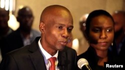 Jovenel Moise addresses the media next to his wife, Martine, after winning the November 20 presidential election in Port-au-Prince, Haiti, Nov. 28, 2016.