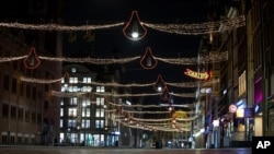 The deserted Damrak street is seen during curfew in the heart of Amsterdam, Jan. 23, 2021. The Netherlands entered its toughest phase of anti-coronavirus restrictions to date, imposing a nationwide curfew from 9 p.m. to 4:30 a.m.